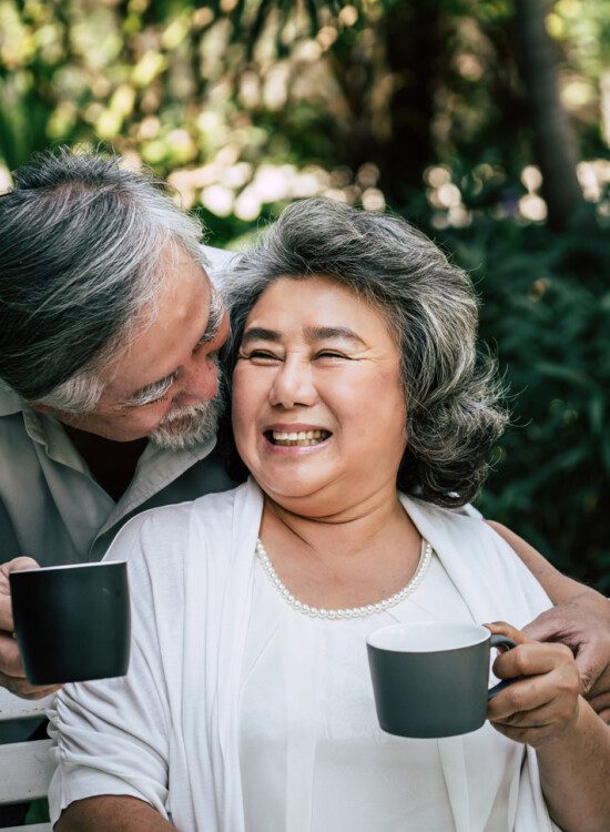 Man hugging woman with coffee