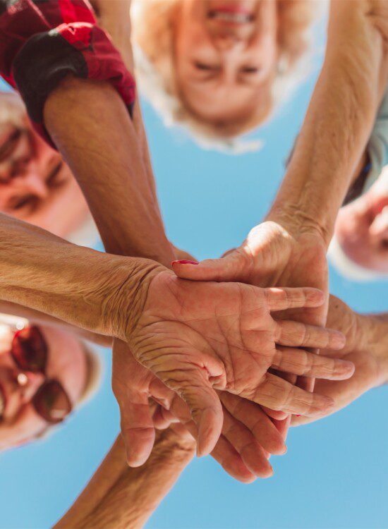 hands on top of each other with faces looking through